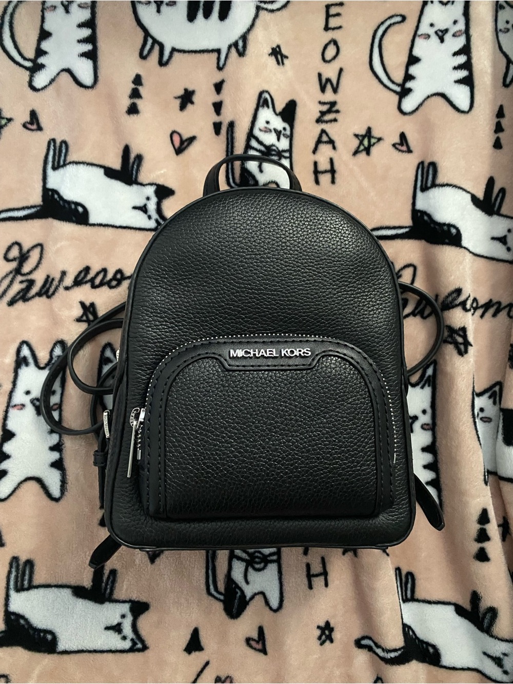 Michael Kors black mini backpack with silver hardware.